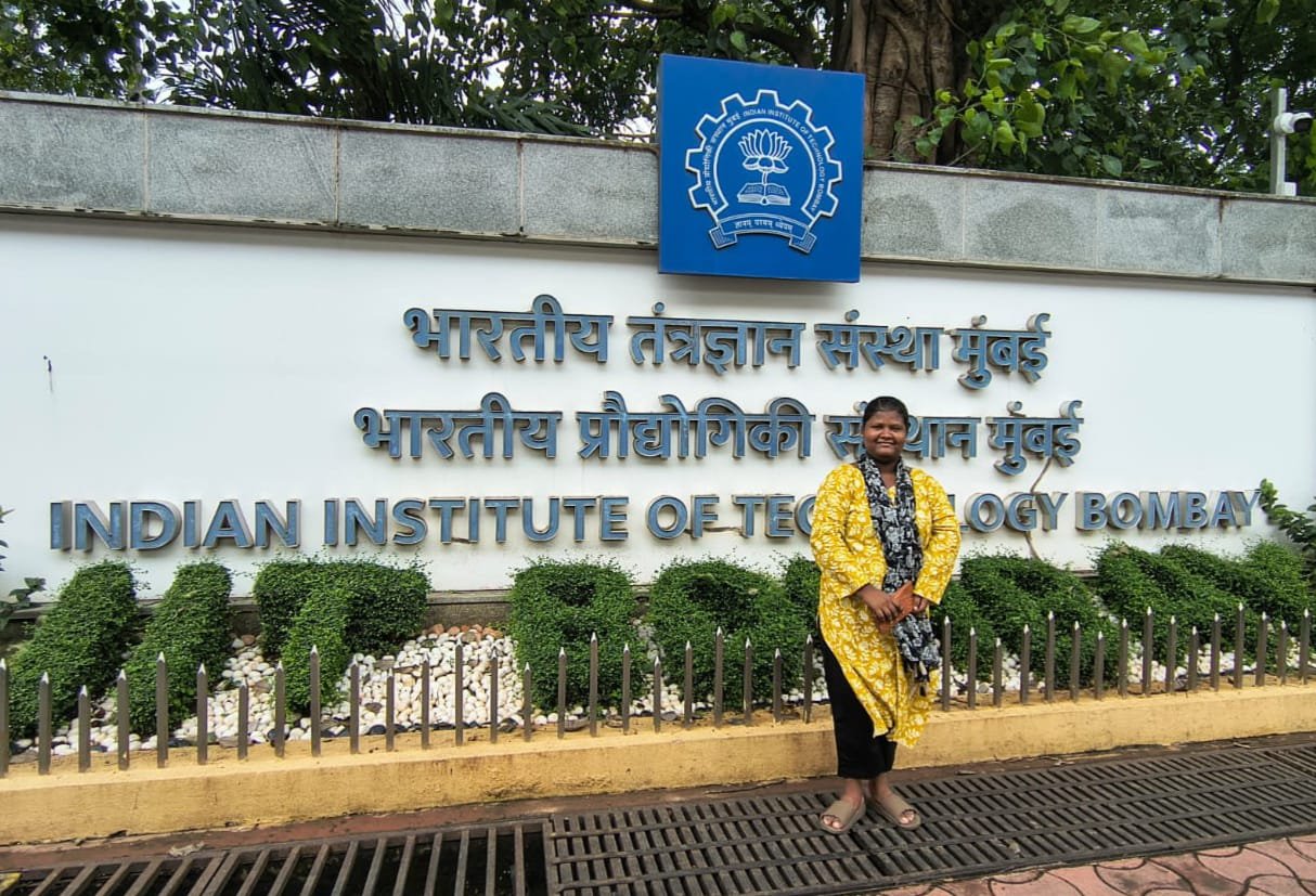 Dhanalakshmi standing at the Indian Institute of Technology Bombay campus gate